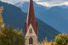 Church spire at Luson with hanglider